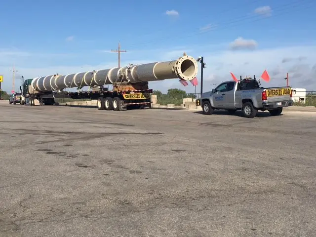 Long tower section on a trailer with a Bonafide pilot truck