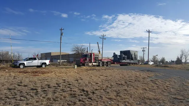Bonafide pilot truck and an oversize load at a rural lot