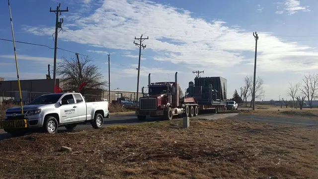 Bonafide pilot truck with a heavy load on a gravel lot