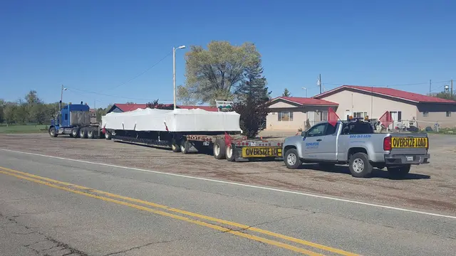 Bonafide escort staged with an oversize load on a two-lane highway