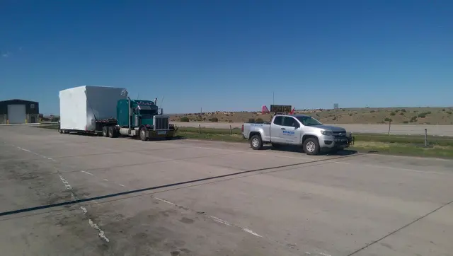 Bonafide pilot truck with a modular building load on the highway
