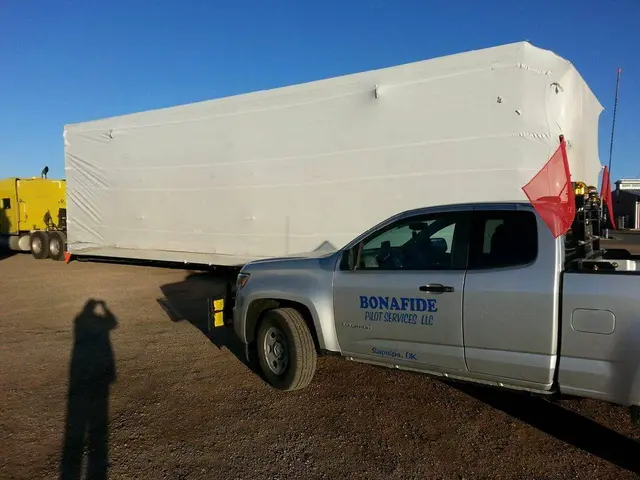 Bonafide pilot truck beside a modular building on a trailer