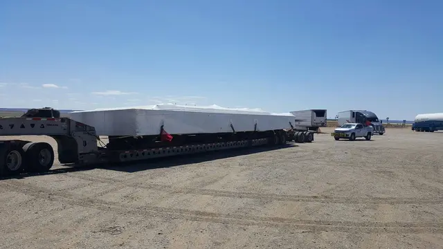 Long flatbed load at a truck stop