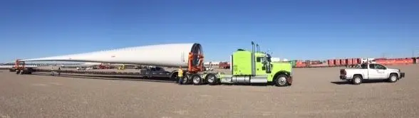 Wind turbine blade on a trailer with a Bonafide pilot truck