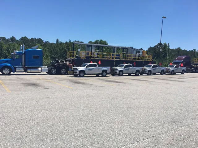 Pilot trucks lined up with a load in a lot