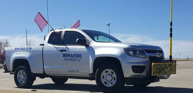 Bonafide pilot truck with flags and a height pole