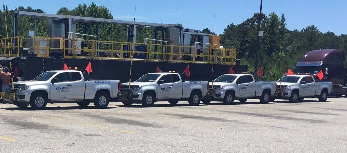 Four Bonafide pilot trucks lined up ahead of a heavy haul move